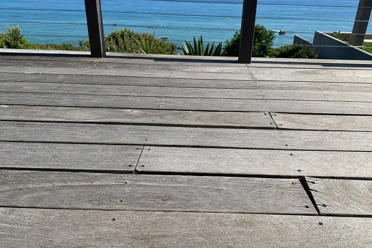Example before: weathered grey deck boards with loose and lifted boards